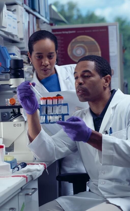 Cancers researchers review samples. Credit: National Cancer Institute