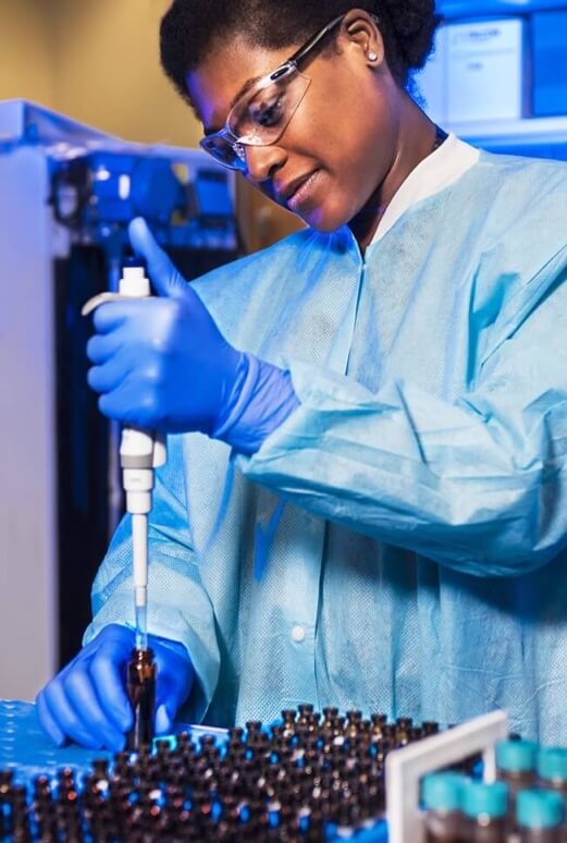 A Centers for Disease Control and Prevention (CDC) laboratory technician, dressed in personal protective equipment (PPE), pipetting samples of bronchoalveolar lavage (BAL) fluid, to undergo analysis in this laboratory. Credit: CDC