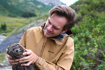 This photograph of Conner Philson, a Ph.D. candidate at the University of California, Los Angeles, was captured by Dave Basden. Conner is holding a baby marmot which was trapped and safely released unharmed as part of a 61-year-long study into their population dynamics, life history and behavior, and response to climate change. Started in 1962, the yellow-bellied marmot project at the Rocky Mountain Biological Laboratory in Colorado has trained biology students and scientists for decades as one of the longest running studies of free-living mammals in the world. Credit: Dave Basden