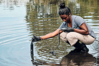 Swathi Manivannan using a water sampling probe at MLK Park, Orlando, FL. Research being conducted for Andrea Ayala's project In Hot Water - Waterfowl, Climate Change, and Vibriosis. Credit&#58; Allaire Bartel