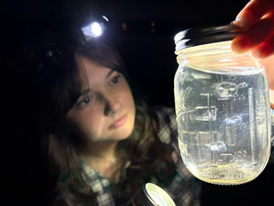 Claire Kozal holds a jar of freshwater jellyfish from southeastern Michigan lakes. Credit: Claire Kozal